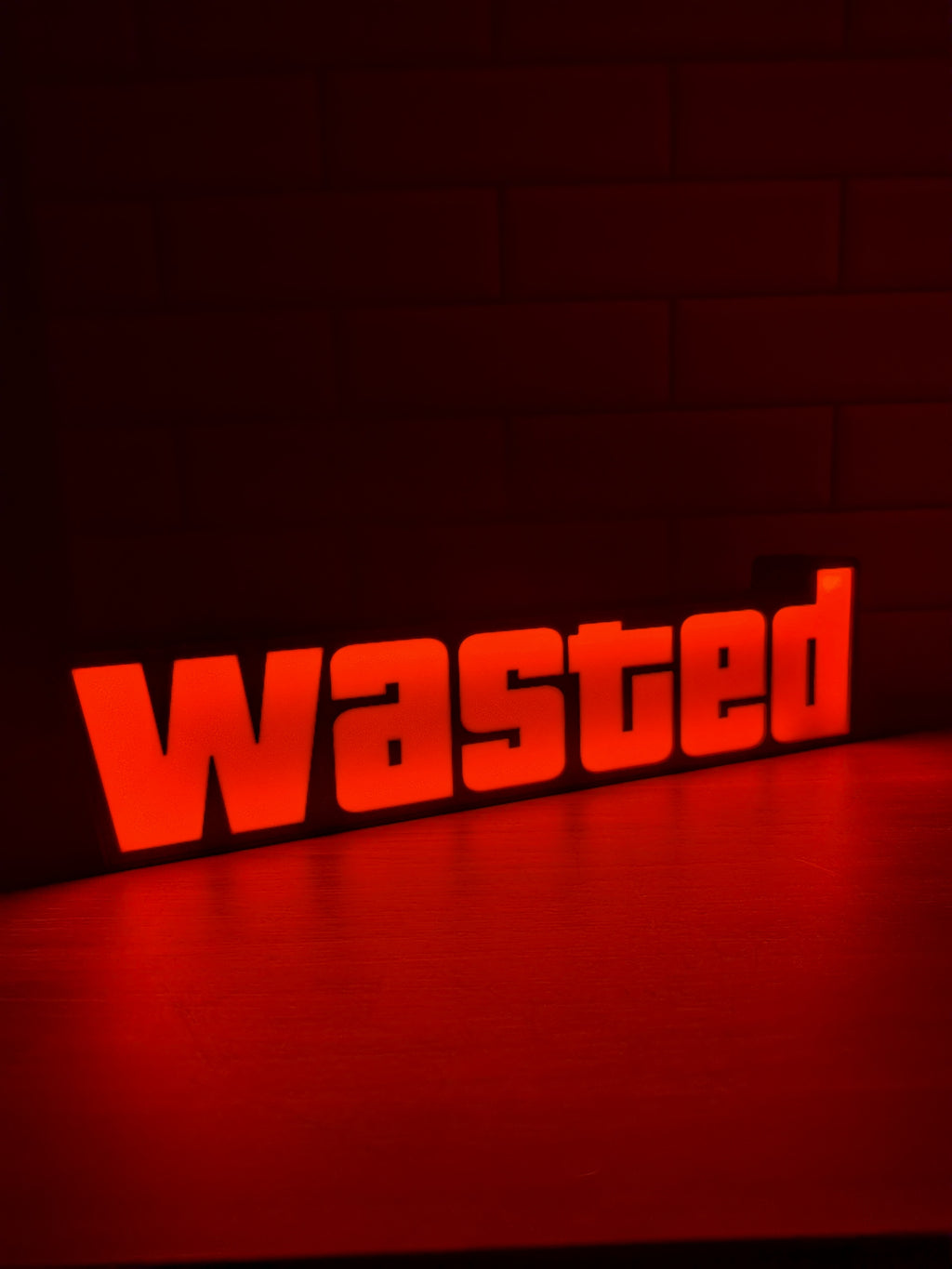 Wasted LED sign 3D printed and glowing on a shelf as gamer room decor