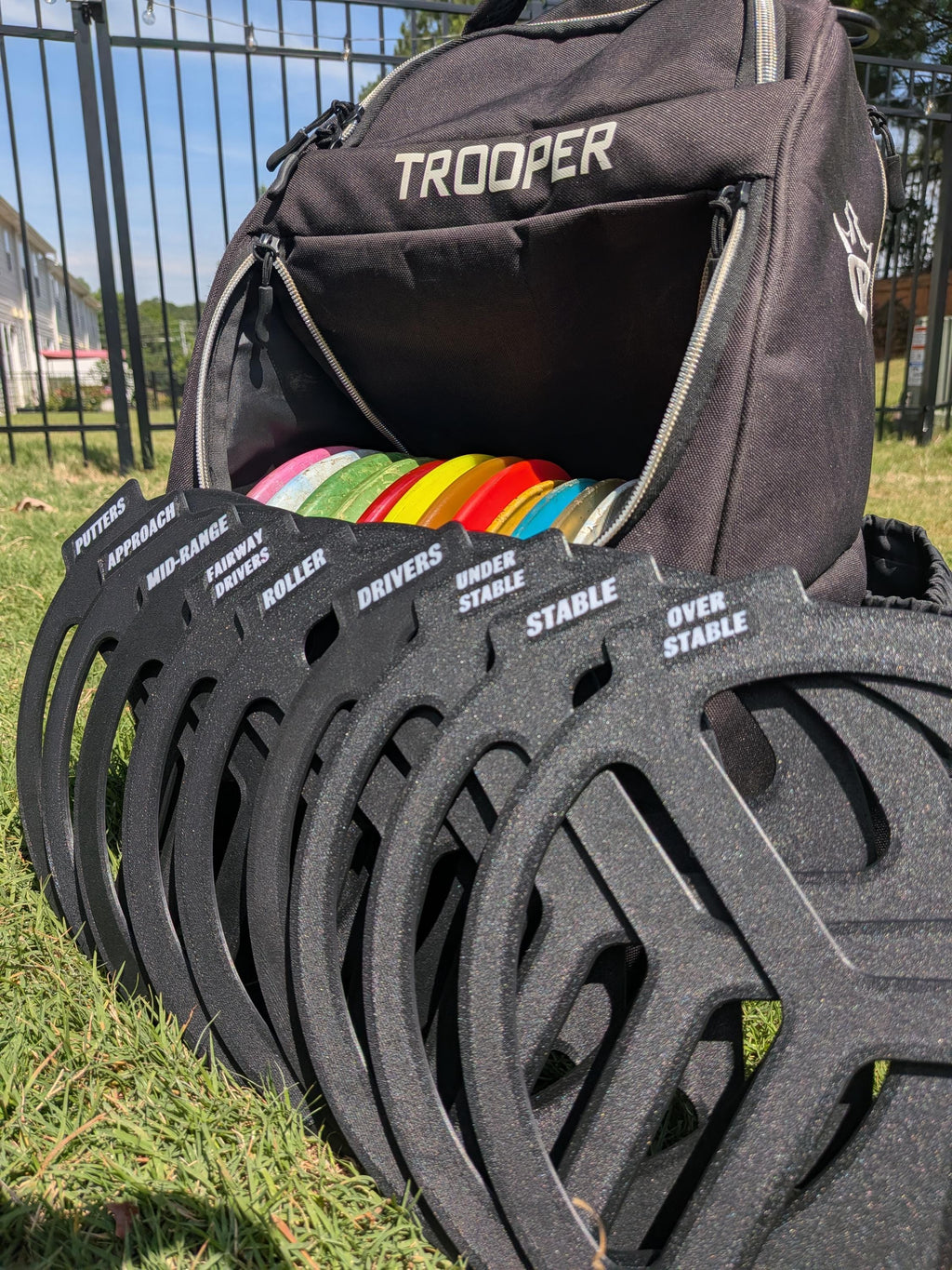 Disc golf bag dividers organizing discs by type inside a bag